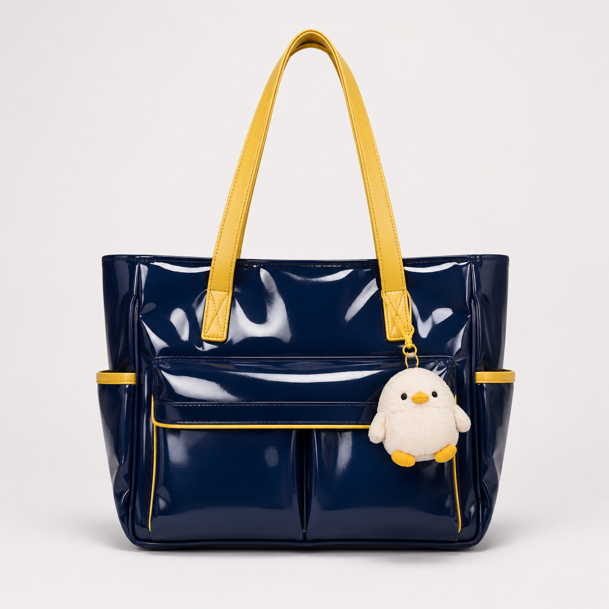 Navy custom bag with yellow handles and plush charm